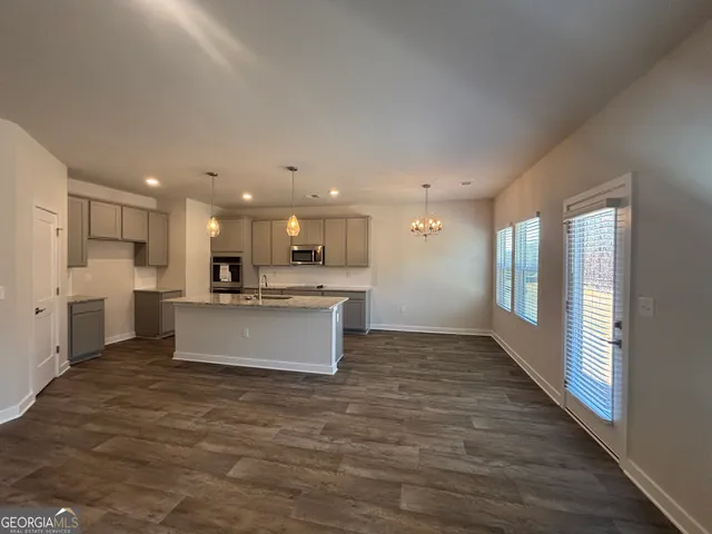a large kitchen with a center island and stainless steel appliances