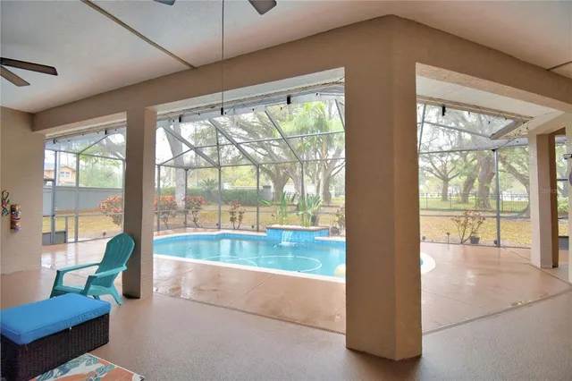 a view of a house with backyard and sitting area