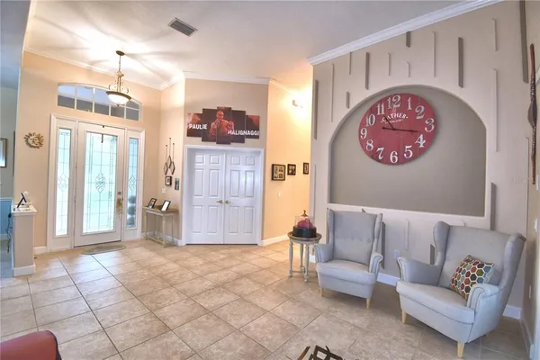 a dining room with furniture a chandelier and wooden floor