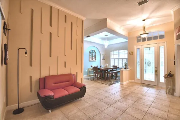 a dining room with furniture a rug and a chandelier
