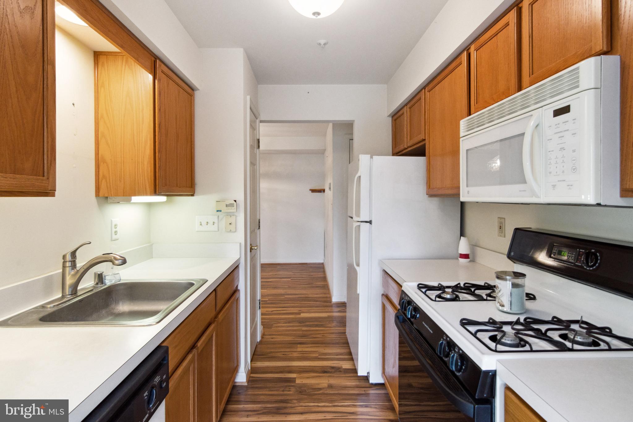 3830 Normandy Drive, Unit 2B Hampstead, MD 21074 - Photo 12 of 25 Gas stove and built-in microwave