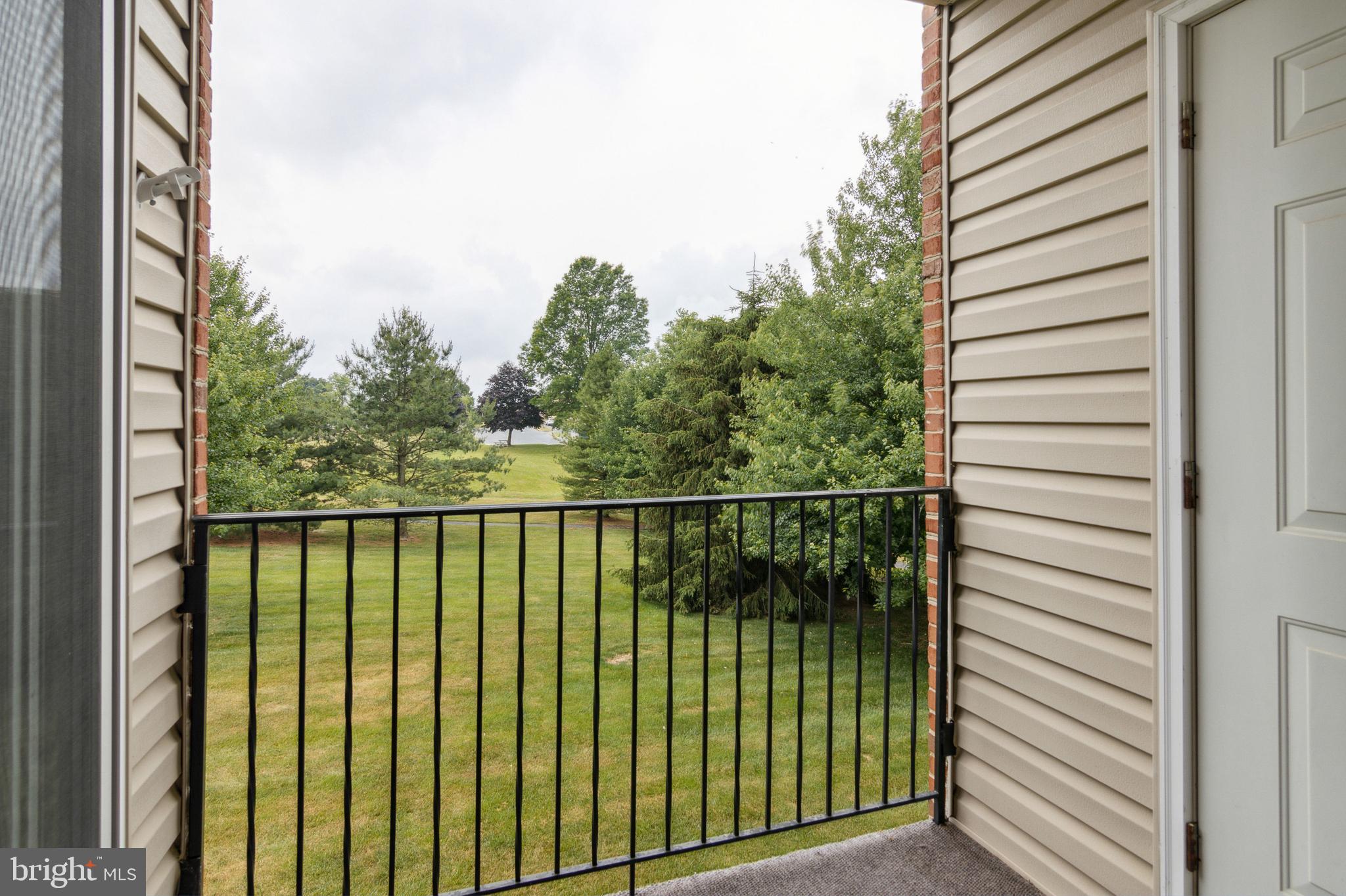 3830 Normandy Drive, Unit 2B Hampstead, MD 21074 - Photo 25 of 25 Great view of lawn and trees from deck