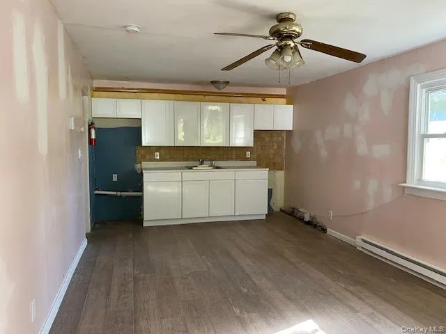a kitchen with a sink a refrigerator and cabinets