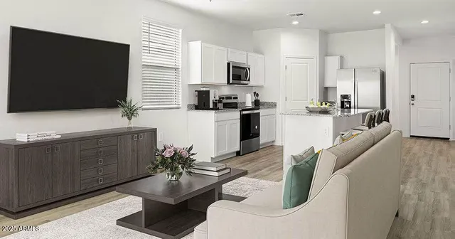 a kitchen with stainless steel appliances kitchen island granite countertop a sink a stove a microwave a dining table and chairs