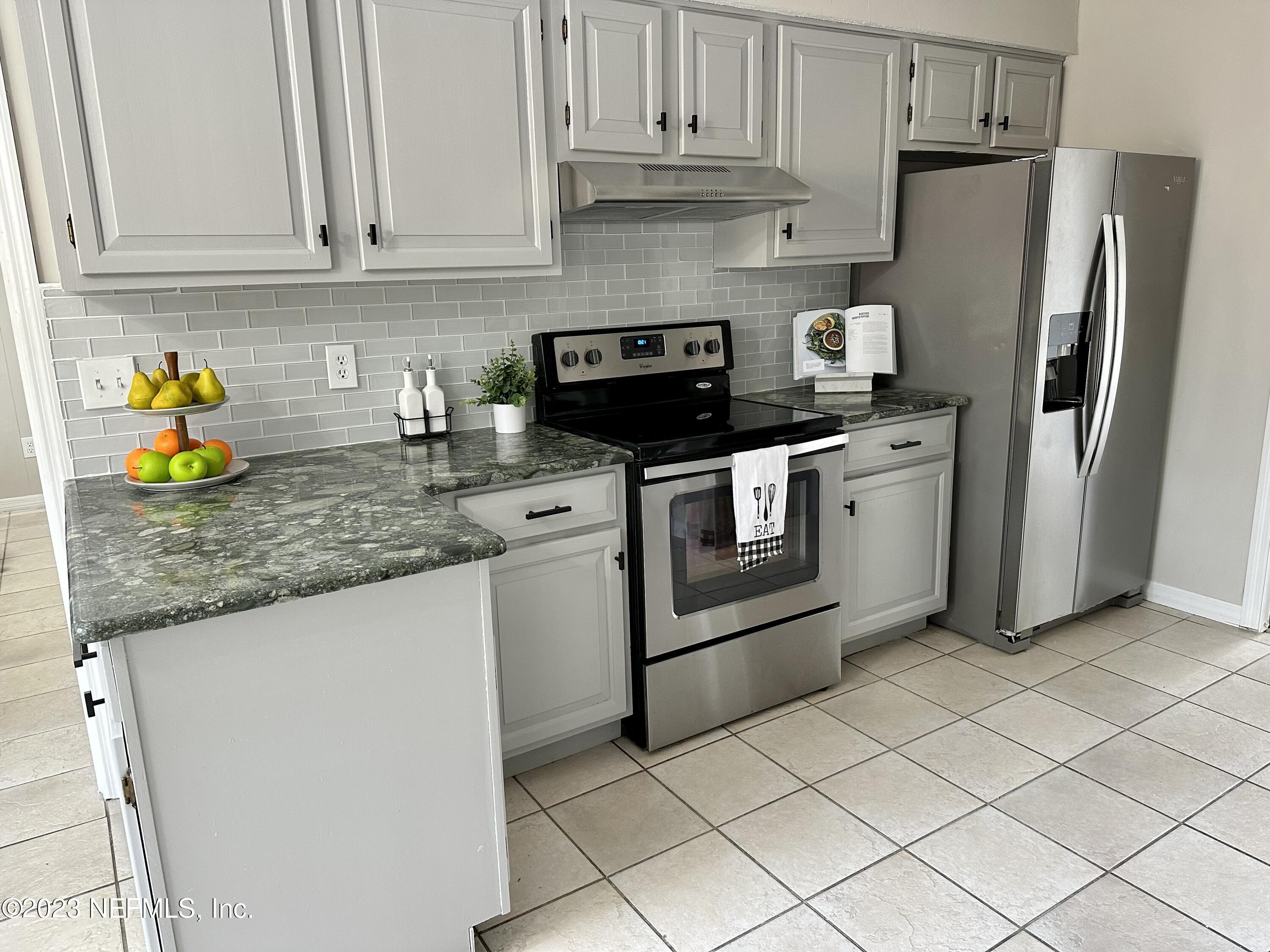 6175 Briar Forest Road West Jacksonville, FL 32277 - Photo 14 of 36 a kitchen with stainless steel appliances granite countertop a refrigerator sink and stove