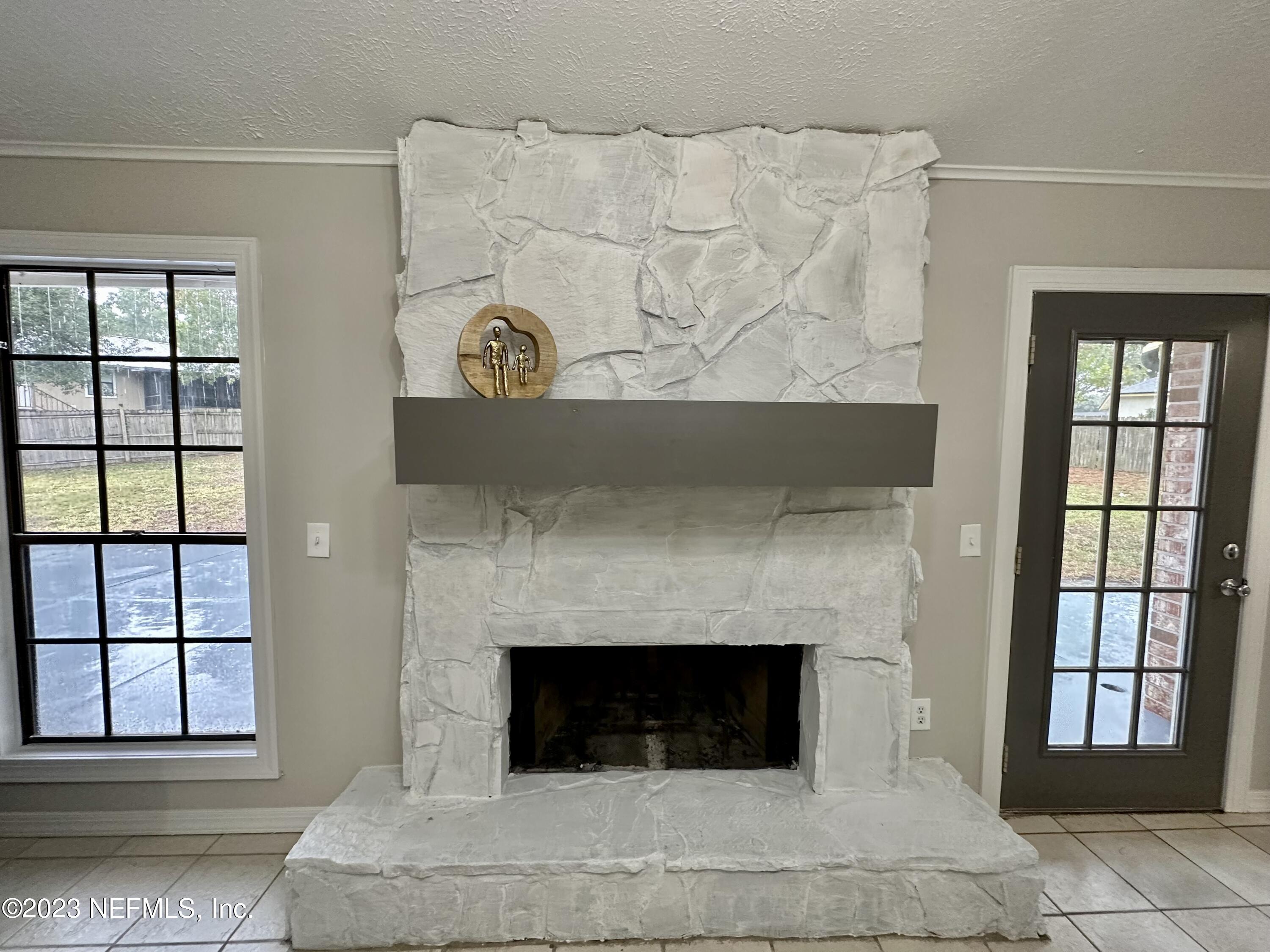 6175 Briar Forest Road West Jacksonville, FL 32277 - Photo 22 of 36 a living room with furniture and a fireplace