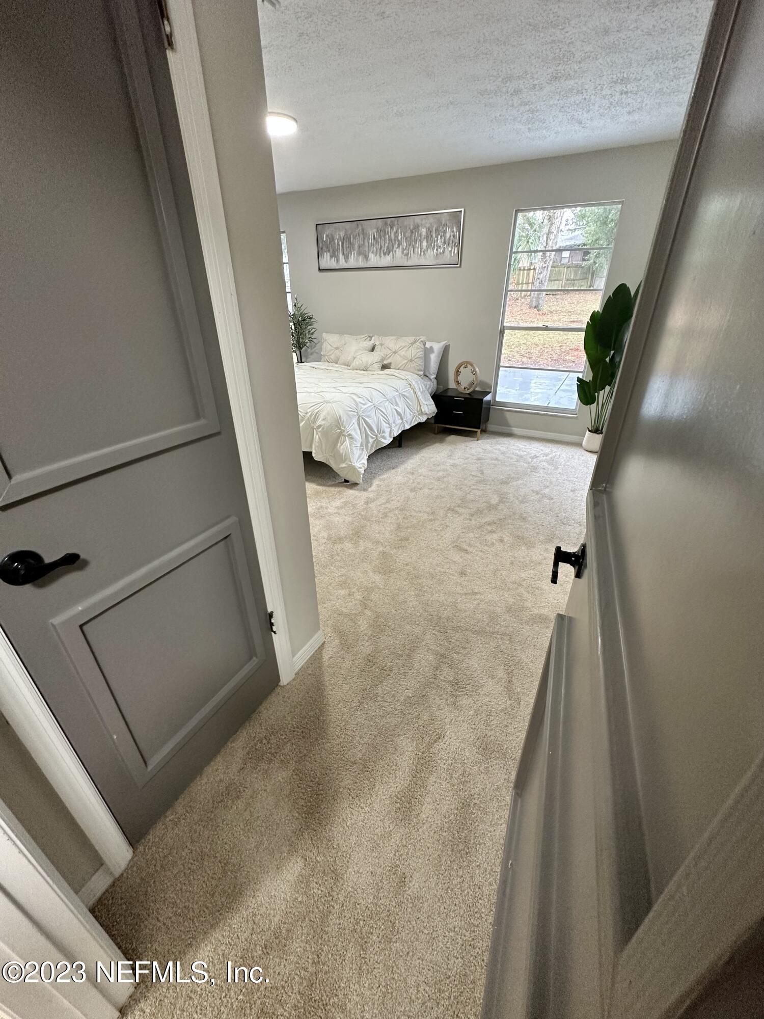 6175 Briar Forest Road West Jacksonville, FL 32277 - Photo 24 of 36 a bedroom with a bed and a couch