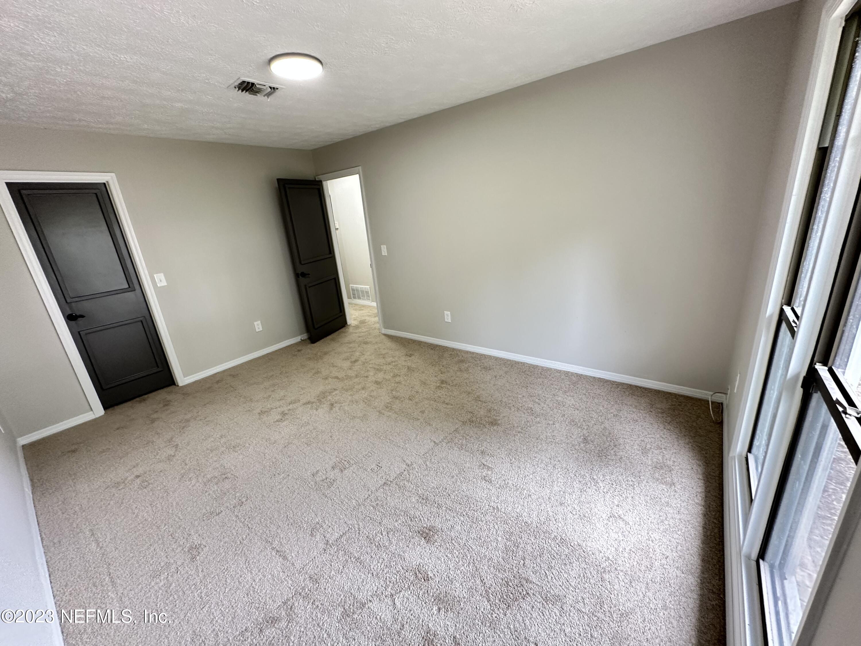 6175 Briar Forest Road West Jacksonville, FL 32277 - Photo 32 of 36 an empty room with a mirror