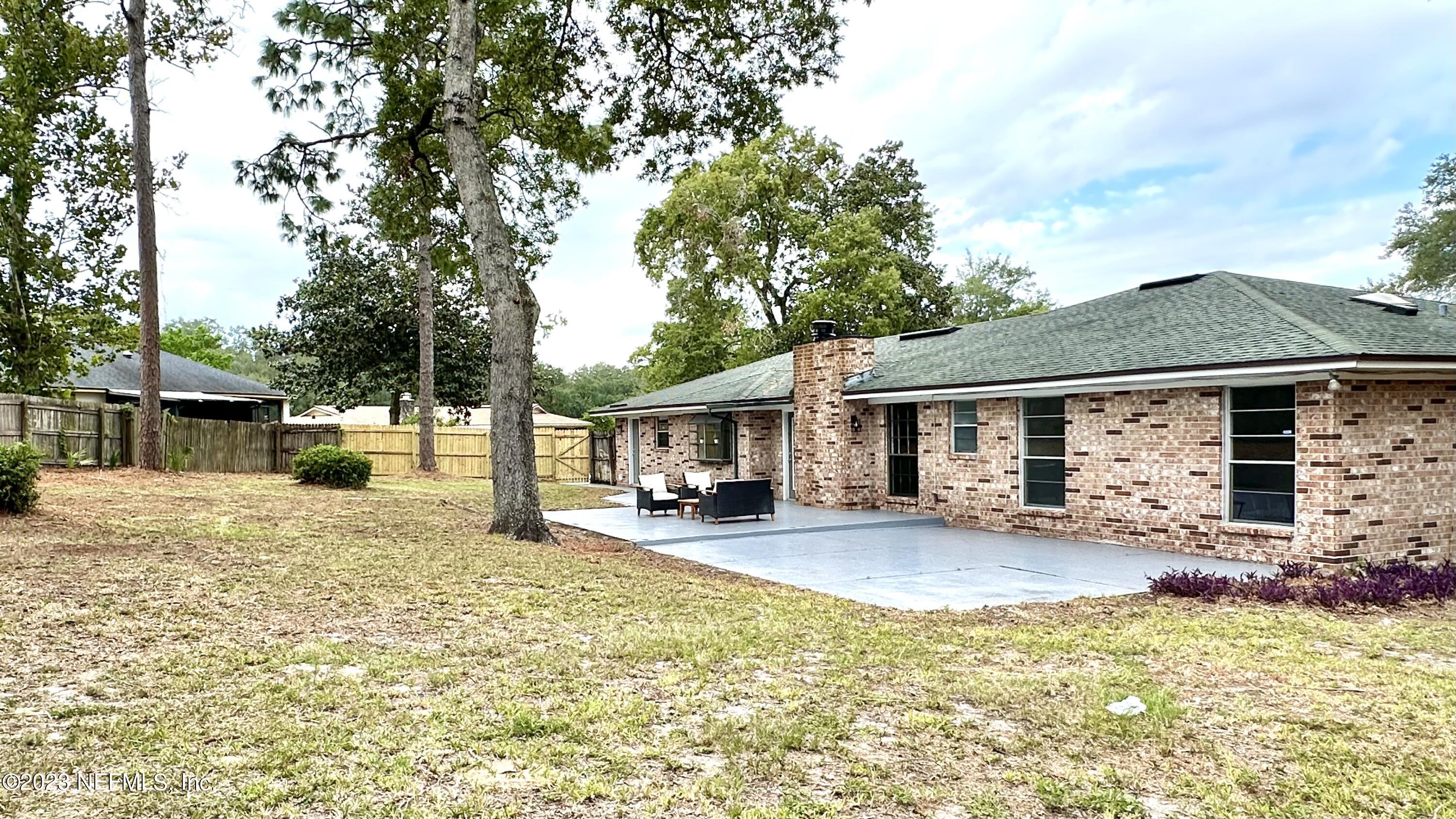 6175 Briar Forest Road West Jacksonville, FL 32277 - Photo 36 of 36 a front view of a house with yard patio and fire pit