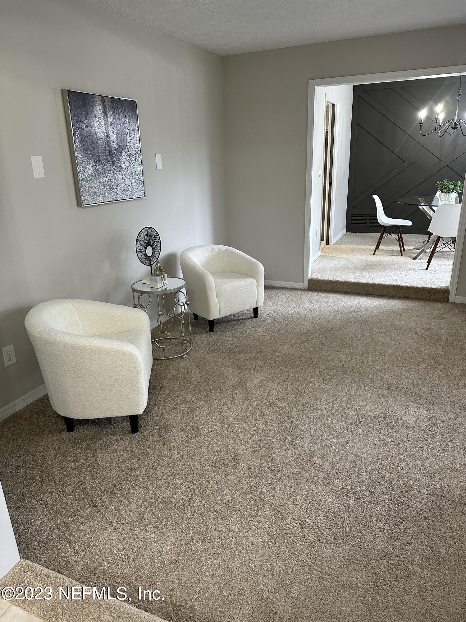 6175 Briar Forest Road West Jacksonville, FL 32277 - Photo 7 of 36 a living room with furniture and a lamp