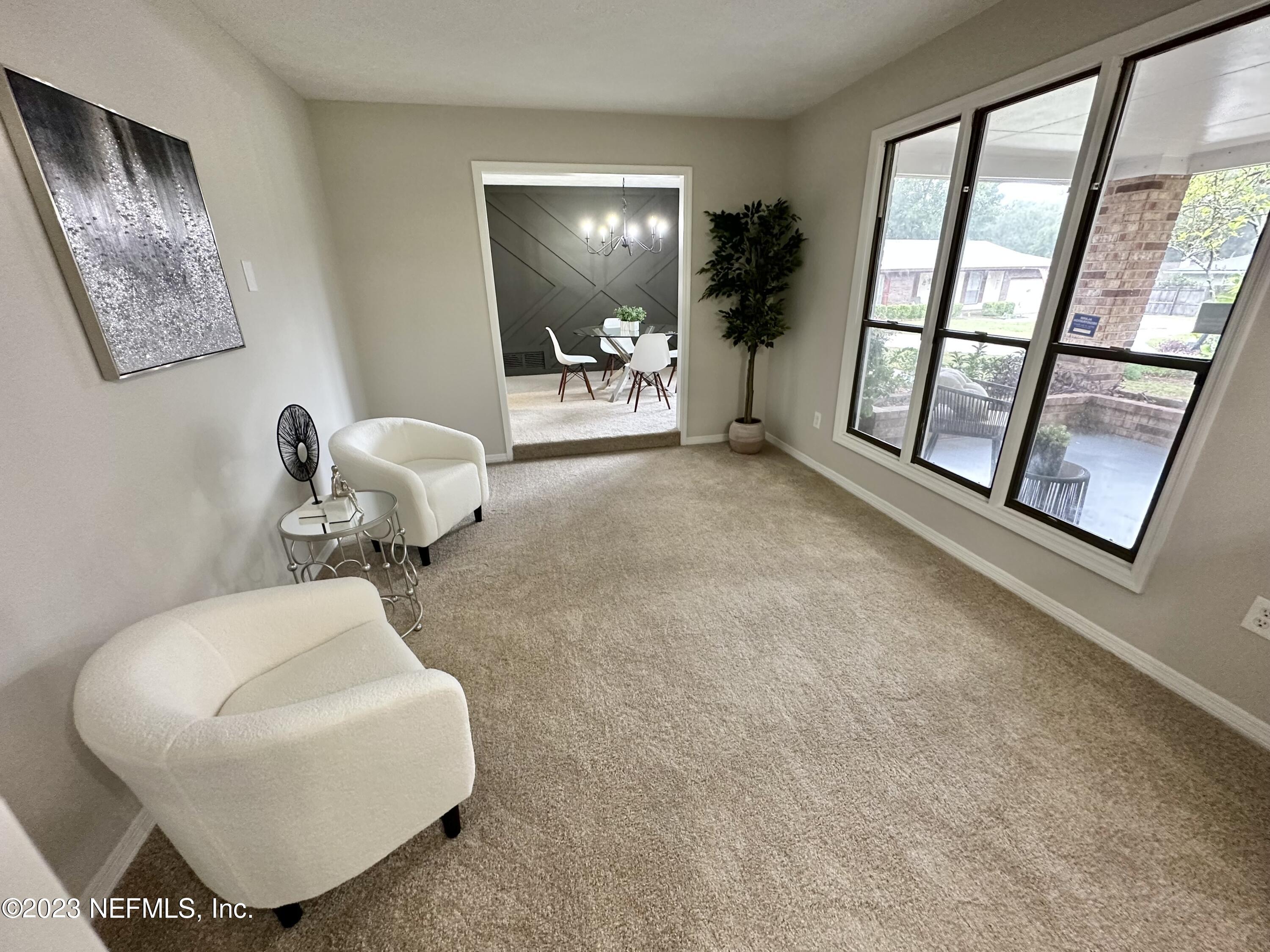 6175 Briar Forest Road West Jacksonville, FL 32277 - Photo 8 of 36 a living room with furniture and a window