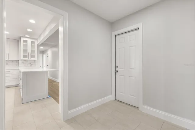 a view of a kitchen with white cabinets