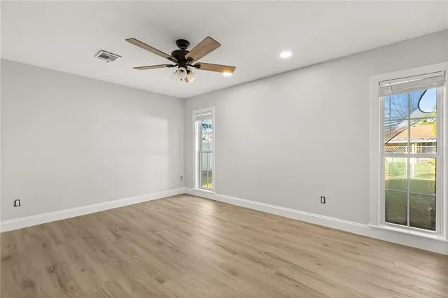 wooden floor in an empty room with a window