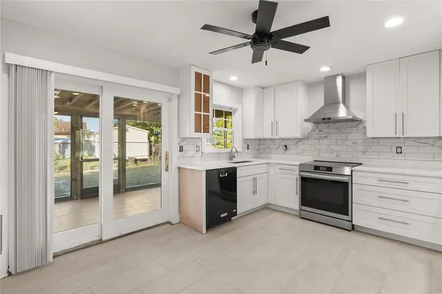 a large kitchen with stainless steel appliances granite countertop a stove and a sink