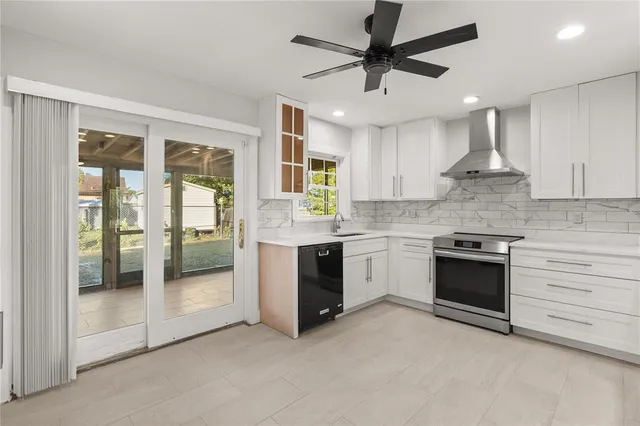 a kitchen with stainless steel appliances granite countertop a stove and cabinets
