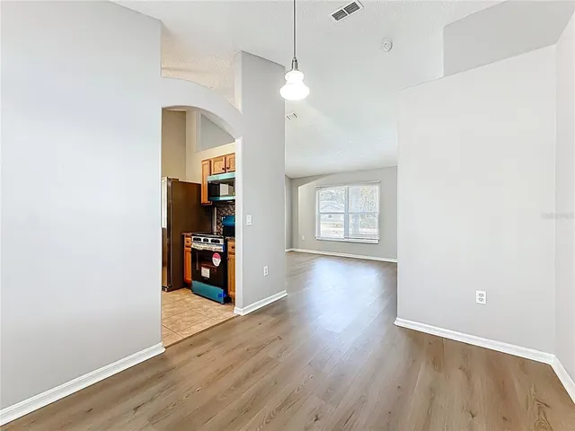 a view of a room with wooden floor and window