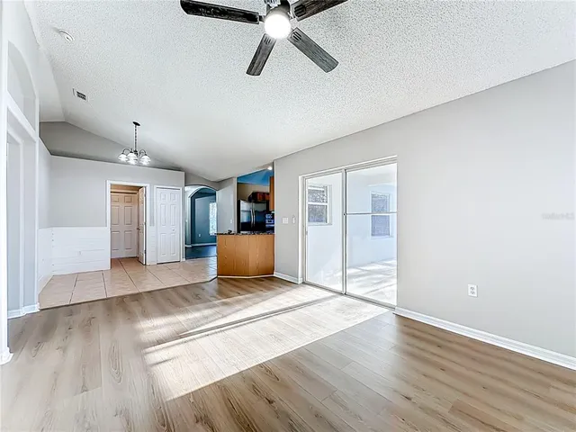 a living room with furniture and a ceiling fan