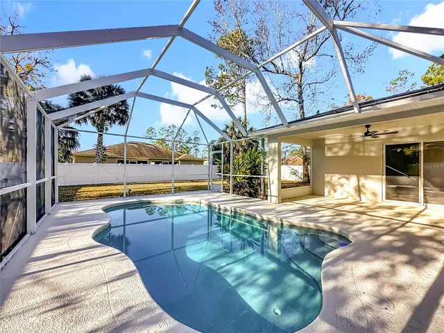 a view of a house with backyard porch and sitting area