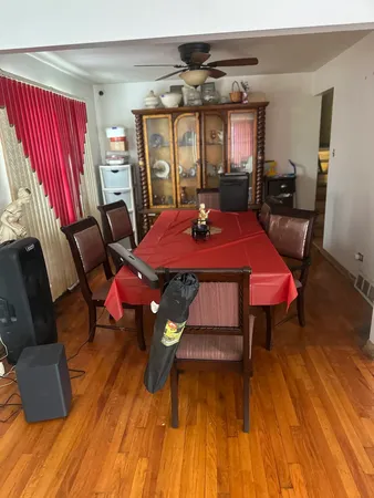 a view of a dining room with furniture and wooden floor