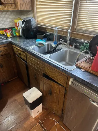 a kitchen with a sink and cabinets