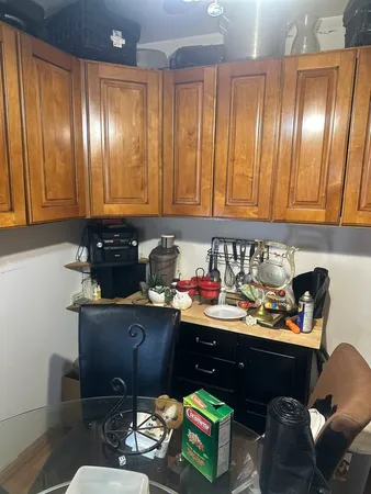 a kitchen with granite countertop lots of wooden cabinets