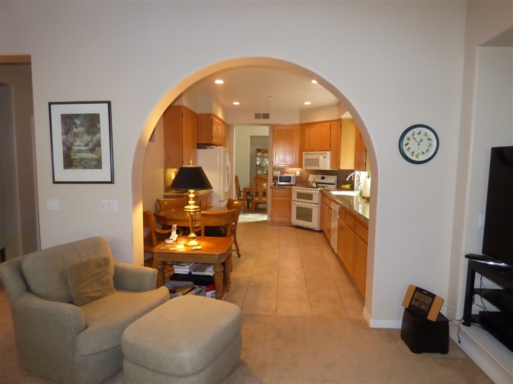 684 Poets Square Fallbrook, CA 92028 - Photo 8 of 25 Arched doorway to kitchen from family room adds so much character.