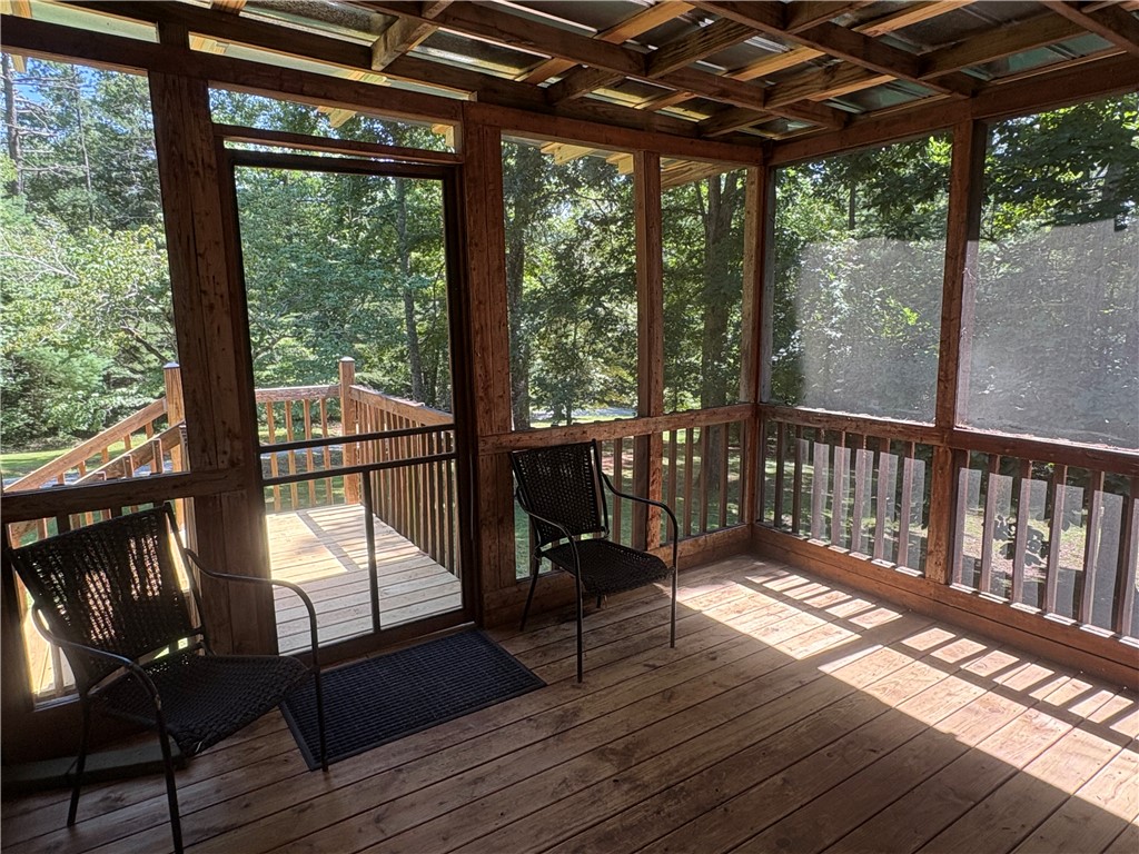 155 Hickory Ridge Mountain Rest, SC 29664 - Photo 3 of 21 A screened porch with exposed wood framing looks out onto the surrounding forest canopy.