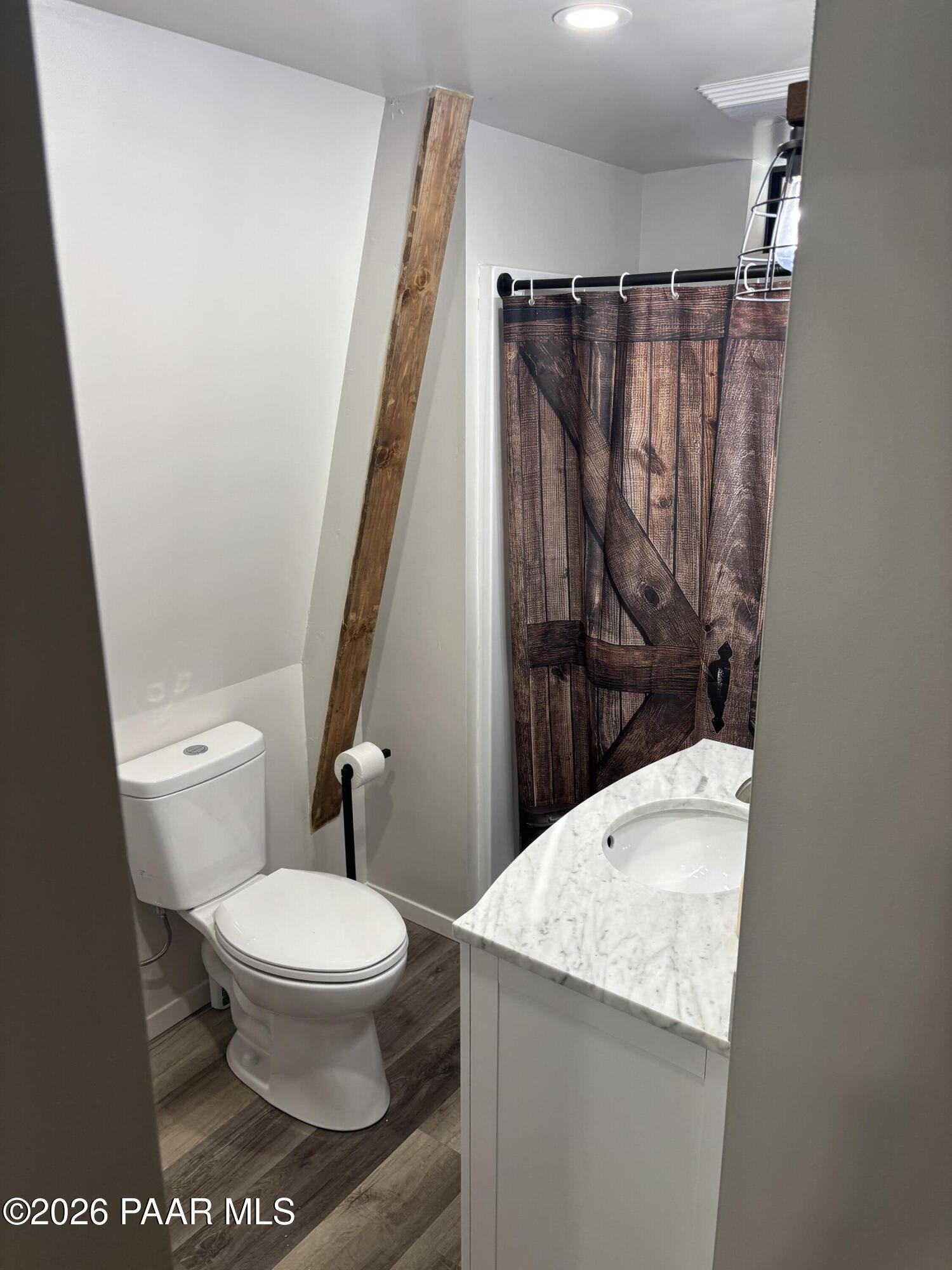8550 South Breezy Pine Road Mayer, AZ 86333 - Photo 22 of 40 a bathroom with a granite countertop toilet and a shower