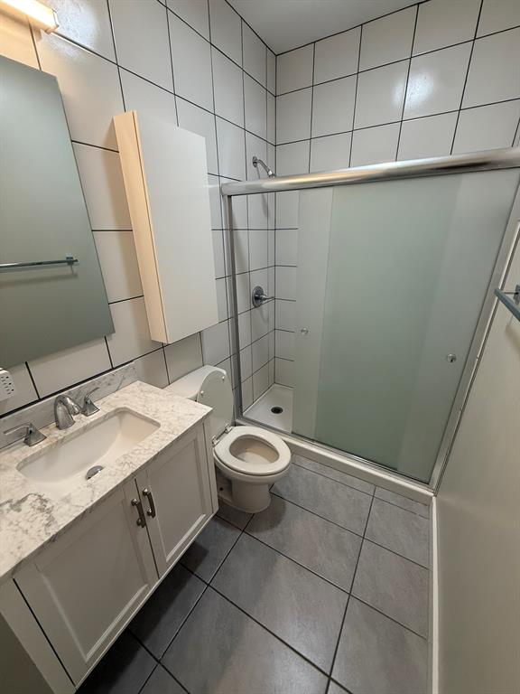 4231 Gilbert Avenue Dallas, TX 75219 - Photo 13 of 14 a bathroom with a granite countertop sink toilet and shower