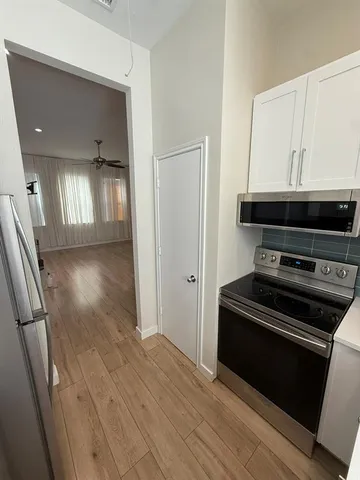 a view of a kitchen from a hallway