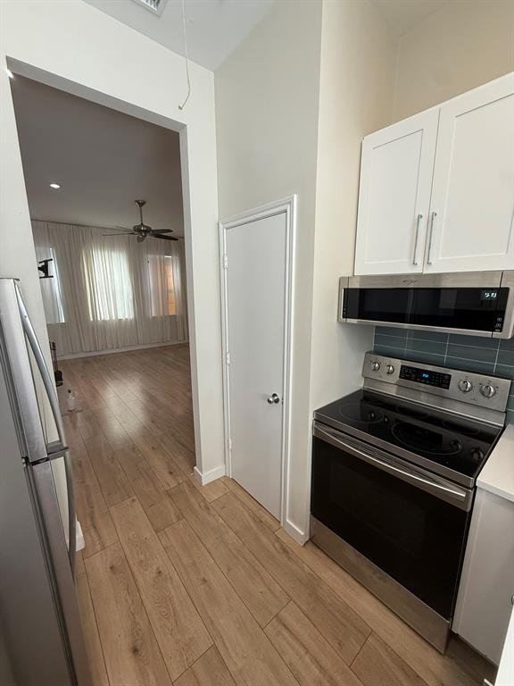 4231 Gilbert Avenue Dallas, TX 75219 - Photo 5 of 14 a view of a kitchen from a hallway