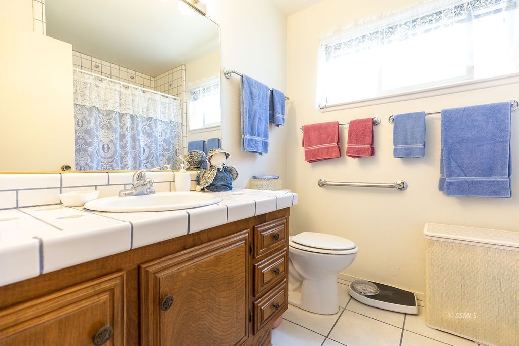 831 Peg Street Ridgecrest, CA 93555 - Photo 19 of 32 a bathroom with a sink toilet and shower