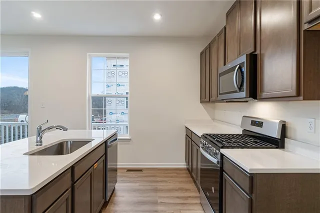 a kitchen that has a sink and a stove