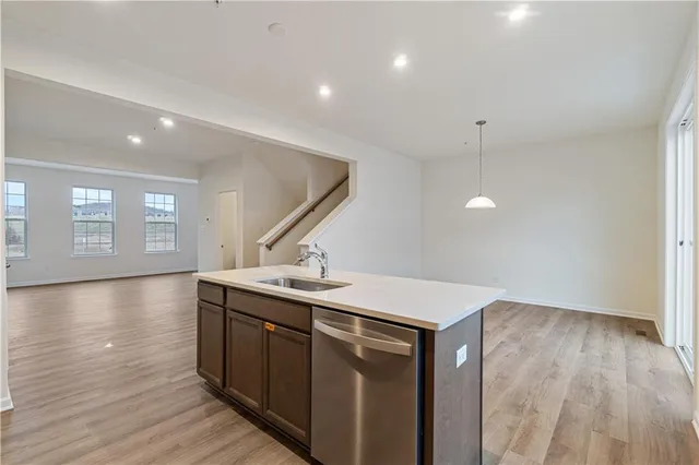 a kitchen with a sink and wooden floor