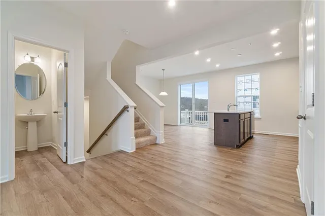 a view of kitchen and hall with wooden floor