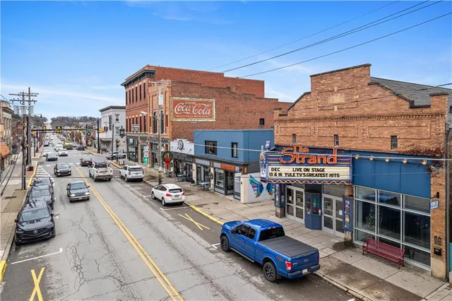 a front view of a house with sitting area
