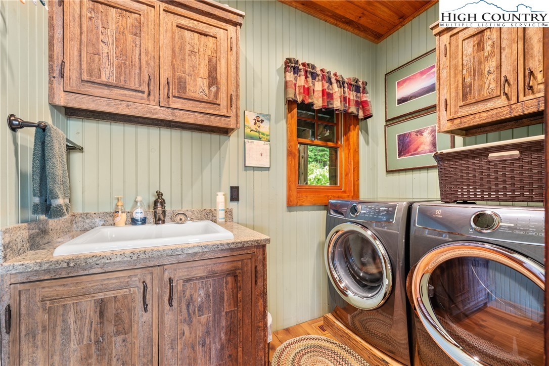 333 Windy Ridge Road Vilas, NC 28692 - Photo 23 of 46 a utility room with stainless steel appliances granite countertop a sink a washer and dryer next to a window