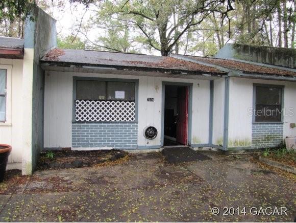 7024 Southwest 18 Place Gainesville, FL 32607 - Photo 1 of 1 a front view of a house with a yard