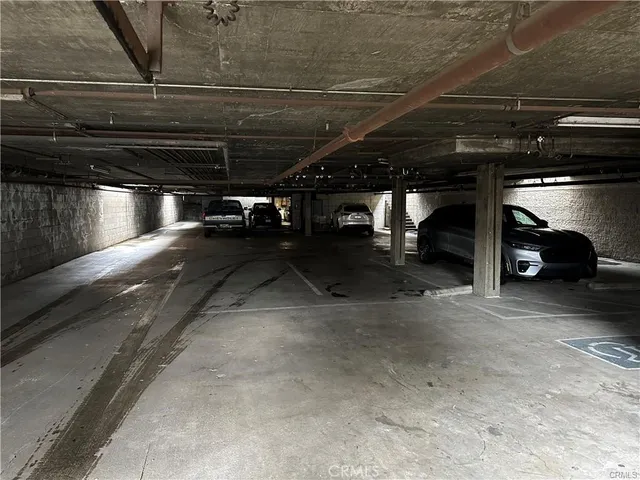 a view of parking garage with cars