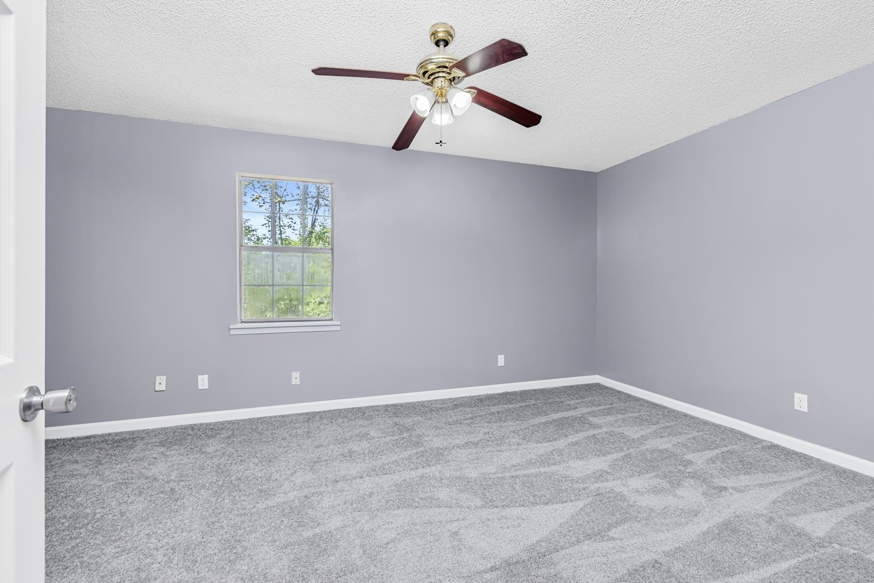 260 Chisolm Trail Road Atoka, TN 38004 - Photo 17 of 30 an empty room with windows and fan