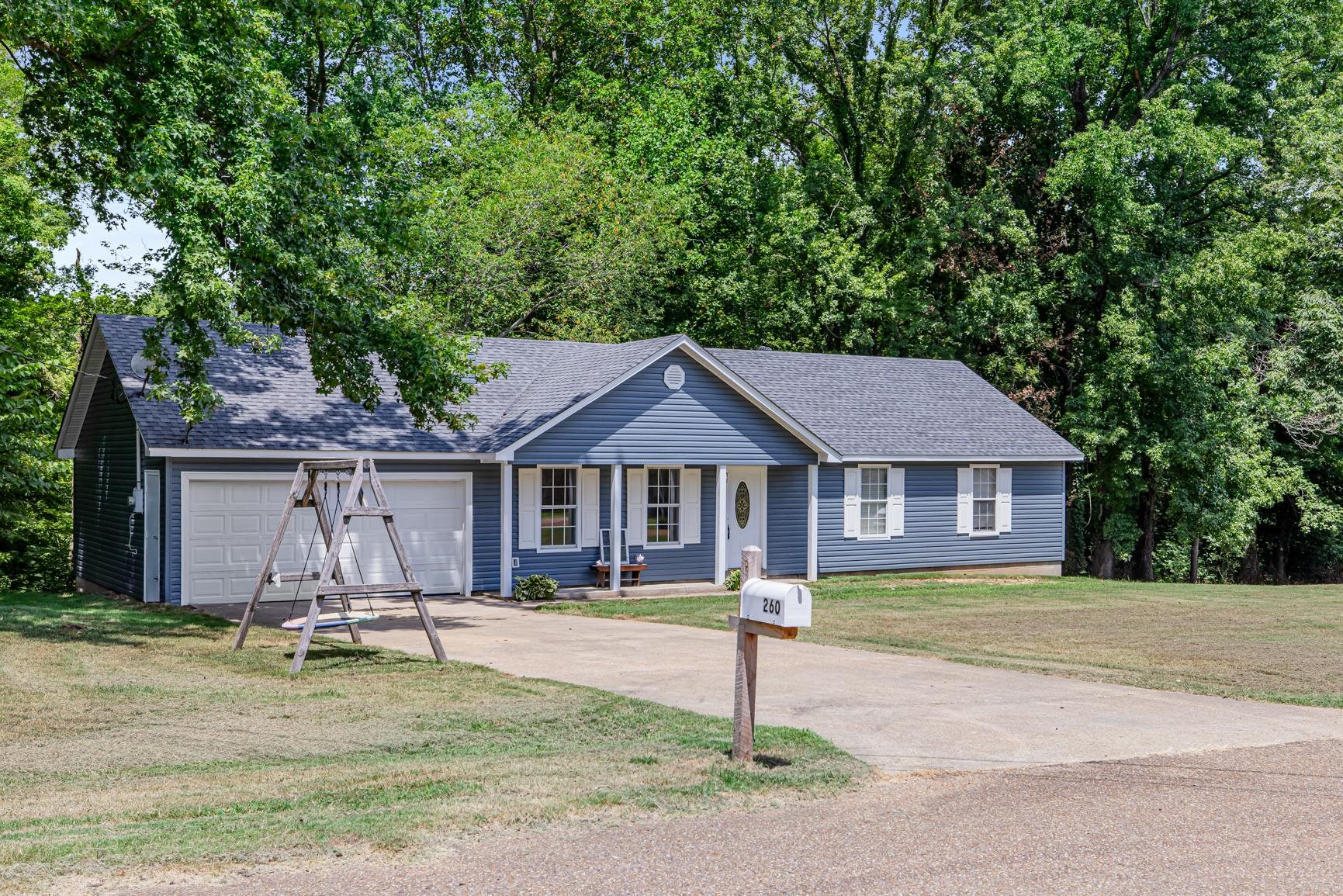 260 Chisolm Trail Road Atoka, TN 38004 - Photo 2 of 30 a view of a house with a yard plants and large tree