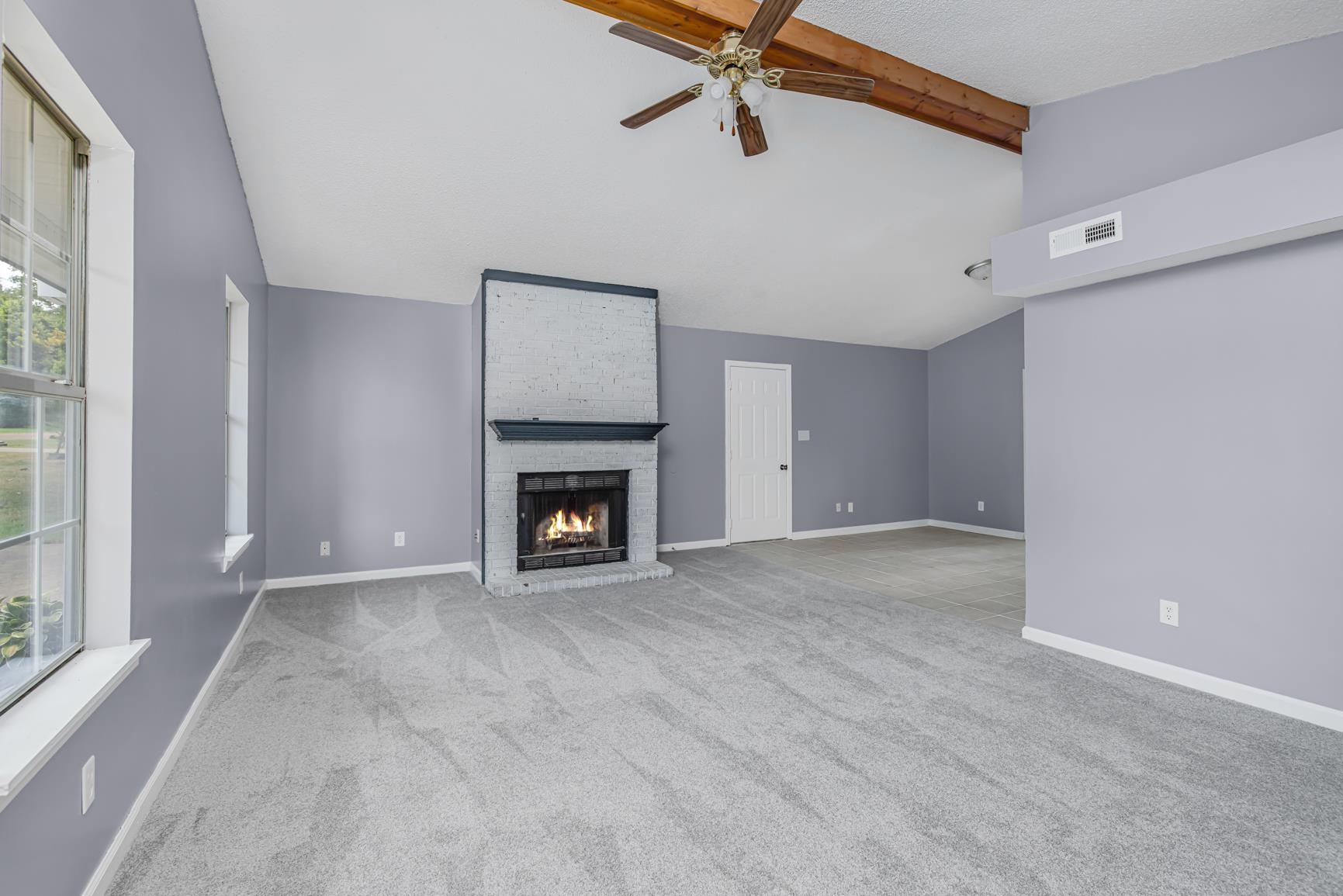 260 Chisolm Trail Road Atoka, TN 38004 - Photo 8 of 30 a view of an empty room with a fireplace and a window