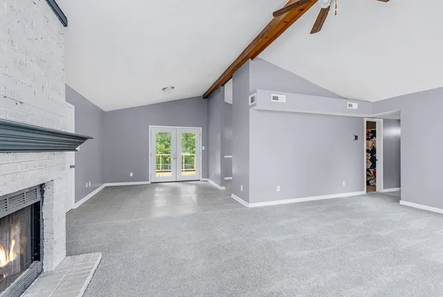 a view of a livingroom with an empty space and a fireplace