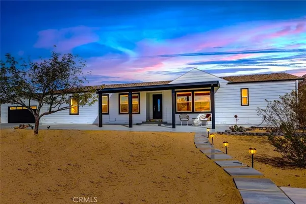 a view of a house with swimming pool and sitting area