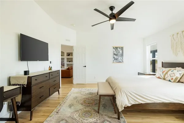 a bedroom with a bed and a flat screen tv
