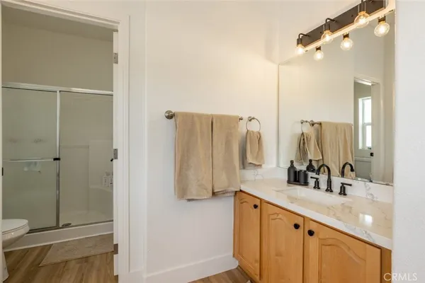 a bathroom with a double vanity sink mirror and toilet