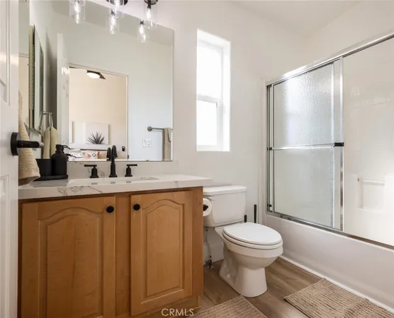a bathroom with a toilet a sink and a mirror