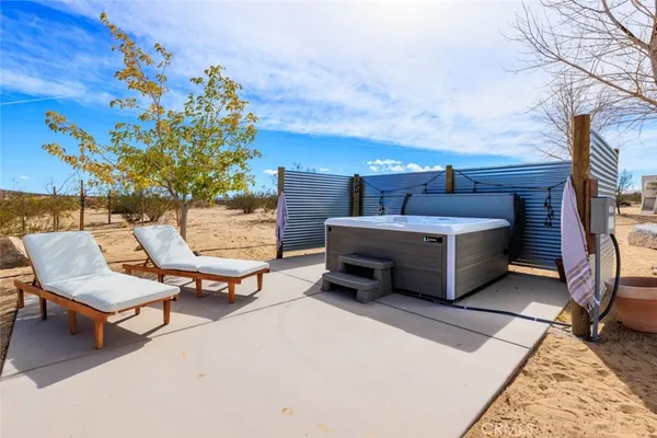 a backyard of a house with table and chairs
