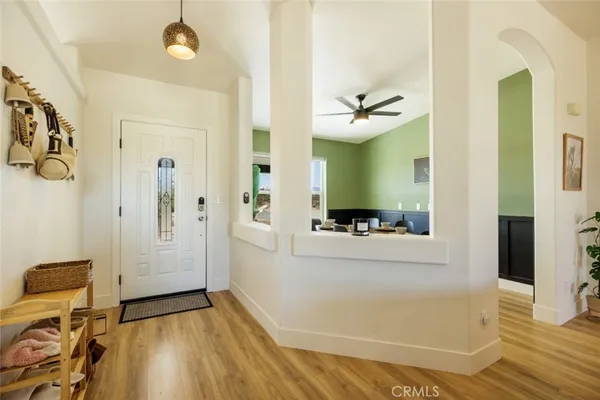 a view of a hallway with bathroom and wooden floor