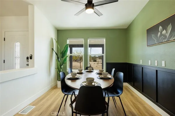 a view of a dining room with furniture window and wooden floor